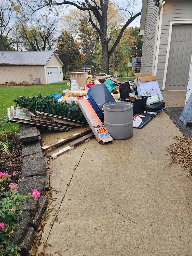 Dumpster being loaded with debris for Estate Cleanout Dumpster Rental in Groveland